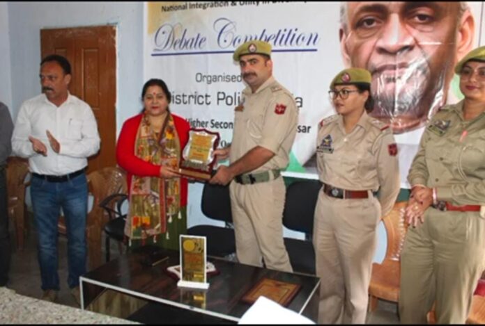Students participating in the debate competition at Assar Police Station