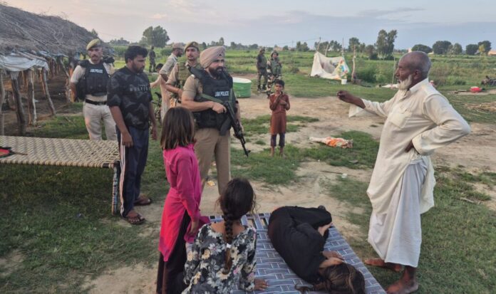 Security personnel conducting a search operation near Jammu border